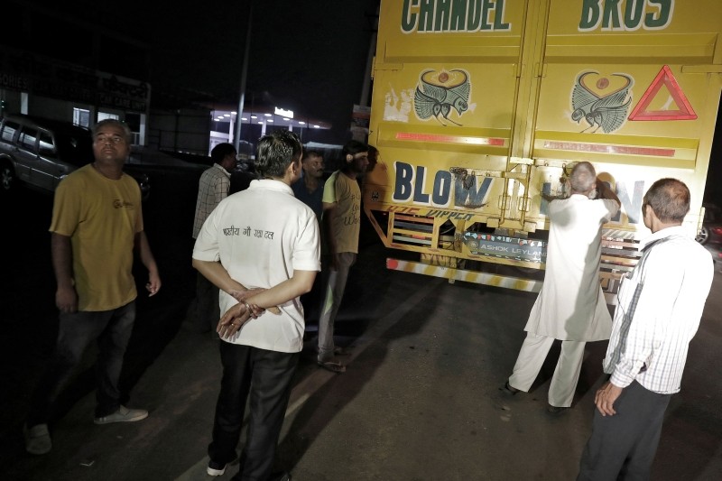 FILE PHOTO: A Muslim driver (second R) prepares to show cow vigilantes the contents of his truck at a road block near Chandigarh, India, July 6, 2017. Picture taken July 6, 2017. REUTERS/Cathal McNaughton/File Photo