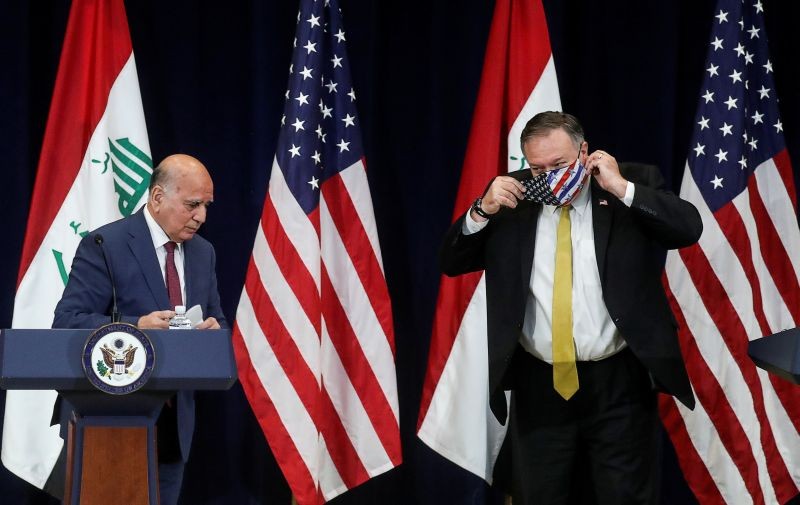 U.S. Secretary of State Mike Pompeo puts on a protective face mask as he and Iraq's Foreign Minister Fuad Hussein face reporters at the State Department in Washington, U.S., August 19, 2020. (REUTERS File Photo)