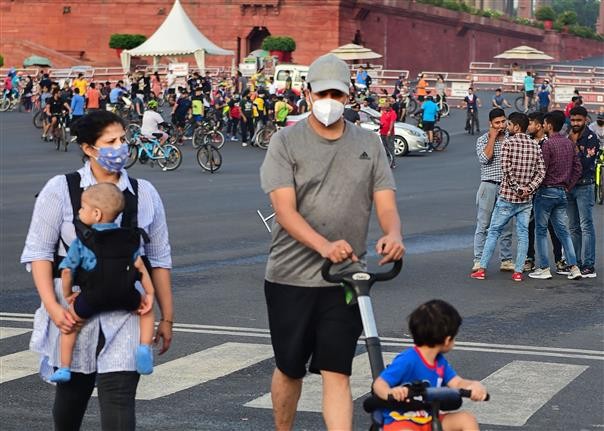 A couple with their children walks at Raisina Hills in New Delhi . (PTI Photo)