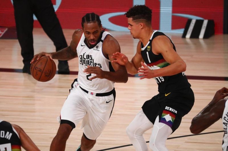 Lake Buena Vista, Florida, USA; LA Clippers forward Kawhi Leonard (2) drives against Denver Nuggets forward Michael Porter Jr. (1) in the first half in game four of the second round of the 2020 NBA Playoffs at AdventHealth Arena. (Credit: Kim Klement-USA TODAY Sports)