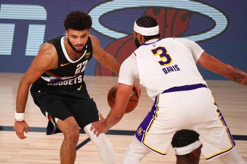 Sep 22, 2020; Lake Buena Vista, Florida, USA; Denver Nuggets guard Jamal Murray (27) dribbles the ball against Los Angeles Lakers forward Anthony Davis (3) during the second half of game three of the Western Conference Finals of the 2020 NBA Playoffs at AdventHealth Arena. (Credit: USA TODAY Sports via Reuters)