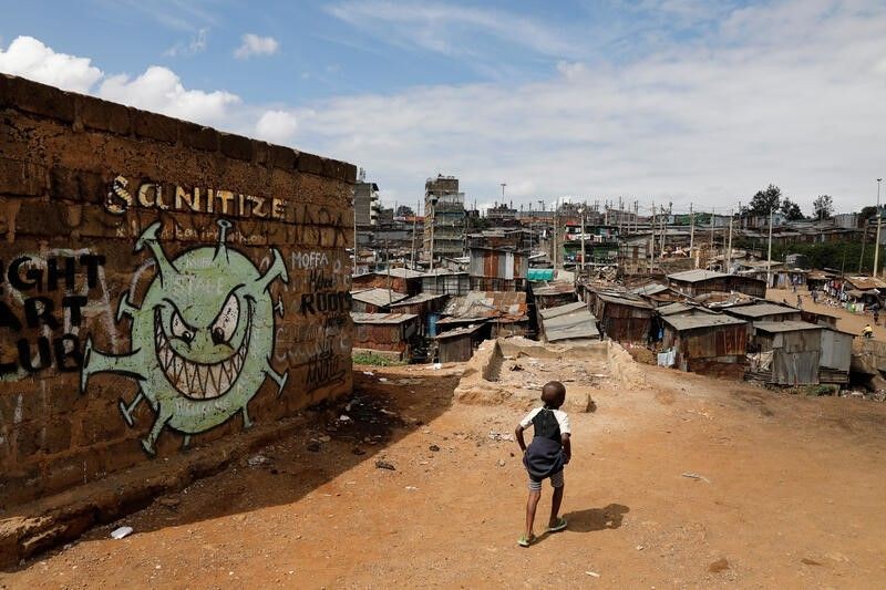 A boy walks in front of a graffiti promoting the fight against the coronavirus disease in the Mathare slums of Nairobi, Kenya on May 22, 2020. (REUTERS File Photo)