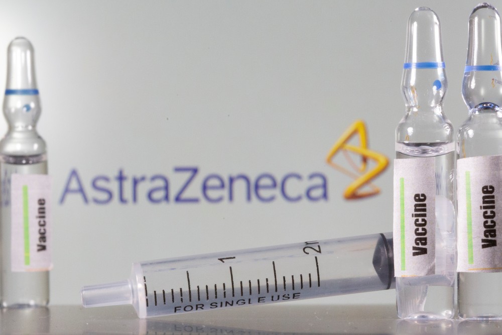 A test tube labelled with the Vaccine is seen in front of AstraZeneca logo in this illustration taken, September 9, 2020. REUTERS/Dado Ruvic/Illustration