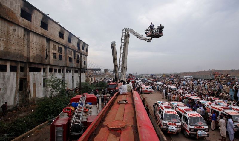 Ambulances and fire brigade vehicles outside a building, after a fire at a garment factory in Karachi September 12, 2012.  (REUTERS File Photo)