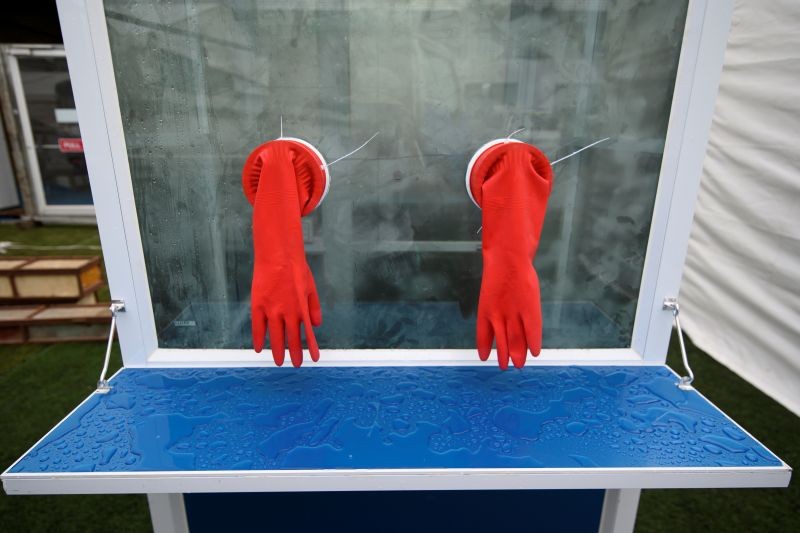 A pair of protective gloves for swab test are seen set up at new quarantine facilities for the coronavirus disease (COVID-19) cases on a football pitch in Yangon, Myanmar on September 16, 2020. (REUTERS File Photo)