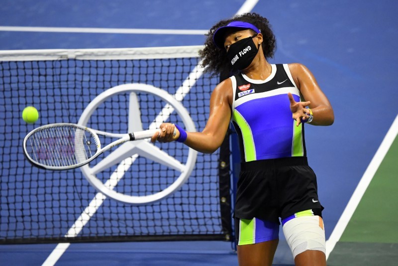 Osaka of Japan wearing a George Floyd mask hits balls into the stands after her win against Shelby Rogers of the United States in the womenÕs singles quarter-finals match on day nine of the 2020 U.S. Open tennis tournament at USTA Billie Jean King National Tennis Center. Robert Deutsch-USA TODAY Sports