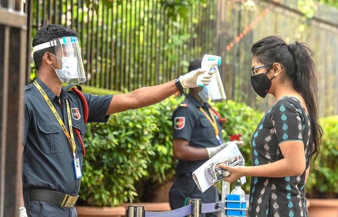 A students undergoes thermal screening as she enters an examination centre to appear for the JEE entrance papers amid the ongoing coronavirus pandemic in Kolkata. Photograph: Ashok Bhaumik/PTI Photo