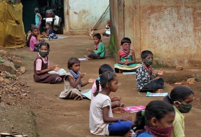 Children at a village in Maharashtra listen to pre-recorded lessons over loudspeakers. Photograph: Prashant Waydande/Reuters
