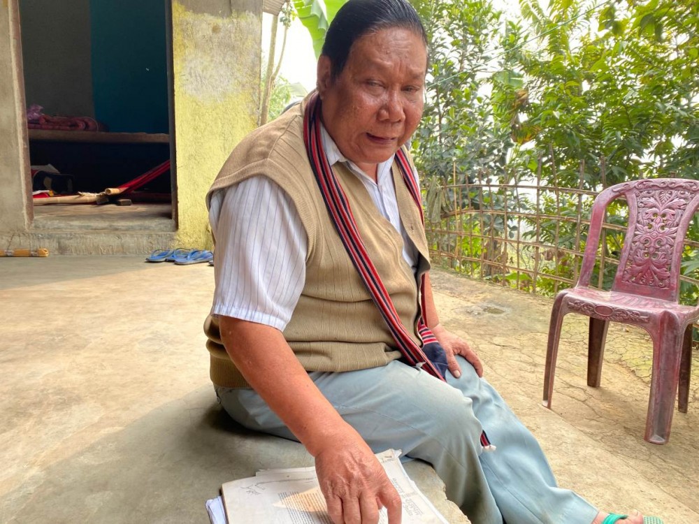 Bankim Chakma points to his handwritten sale deed for the land that he built a house on and has lived in for 20 years, but has no legal title for in an informal hill settlement in Guwahati, Assam in India. January 28, 2020. Thomson Reuters Foundation/Rina Chandran