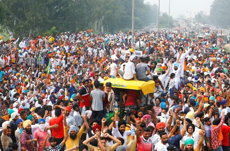 Farmers gesture as they block a national highway during a protest against farm bills passed by India's parliament, in Shambhu in Punjab, India, September 25, 2020. REUTERS/Adnan Abidi