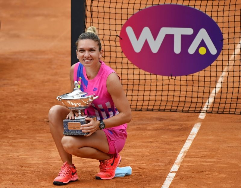 Romania's Simona Halep as she celebrates winning the final with the trophy after Czech Republic's Karolina Pliskova retired from the match after sustaining an injury Riccardo Antimiani/Pool via REUTERS
