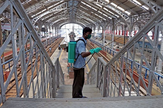 A worker sanitises the foot-over bridge at Egmore railway station in Chennai. Photograph: ANI Photo