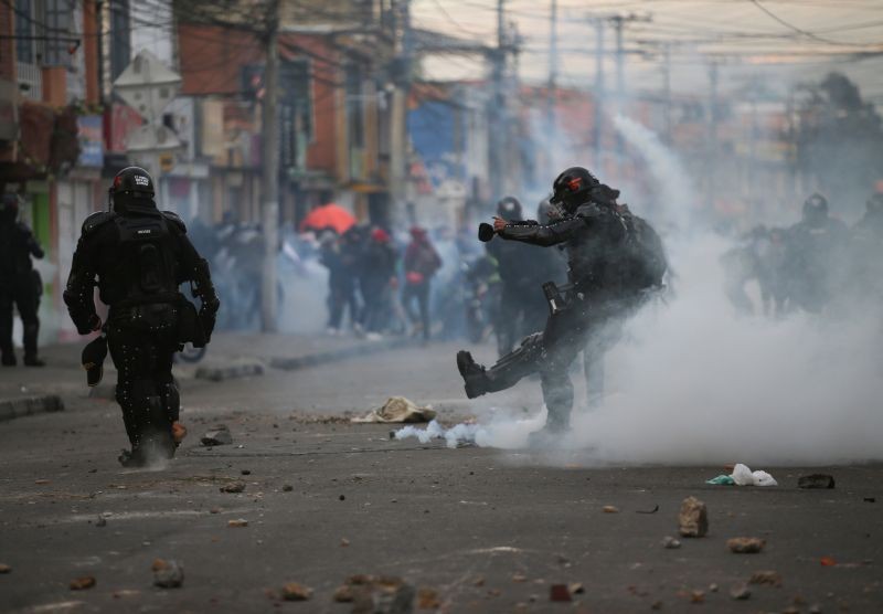 A riot police officer kicks a tear gas canister during clashes with protesters after a man, who was detained for violating social distancing rules, died from being repeatedly shocked with a stun gun by officers, according to authorities, in Bogota, Colombia on September 9, 2020. (REUTERS Photo)