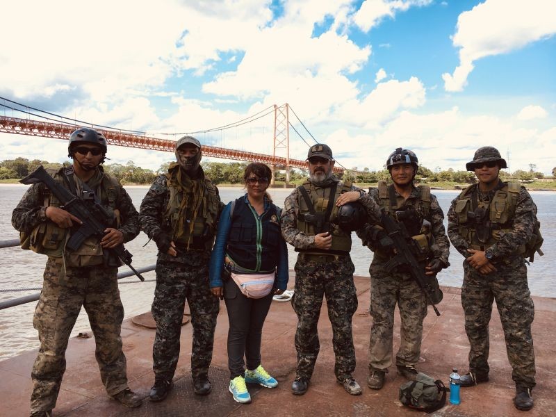 Environmental prosecutor Karina Garay (centre) and the Peruvian navy patrol the Madre de Dios River, Peru, looking for illegal mining activity, Peru on November 26, 2019. (Thomson Reuters Foundation File Photo)