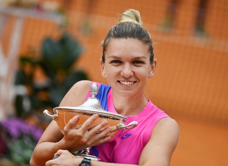 Romania's Simona Halep as she celebrates winning the final with the trophy after Czech Republic's Karolina Pliskova retired from the match after sustaining an injury Riccardo Antimiani/Pool via REUTERS