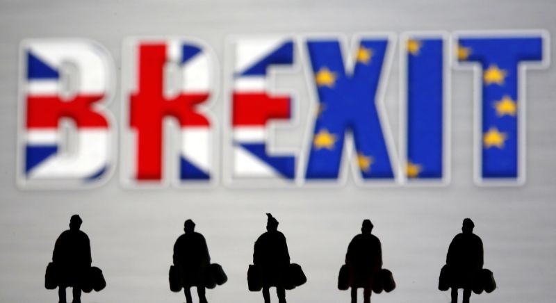 Small toy figures are seen in front of a Brexit logo in this illustration picture on March 30, 2019. (