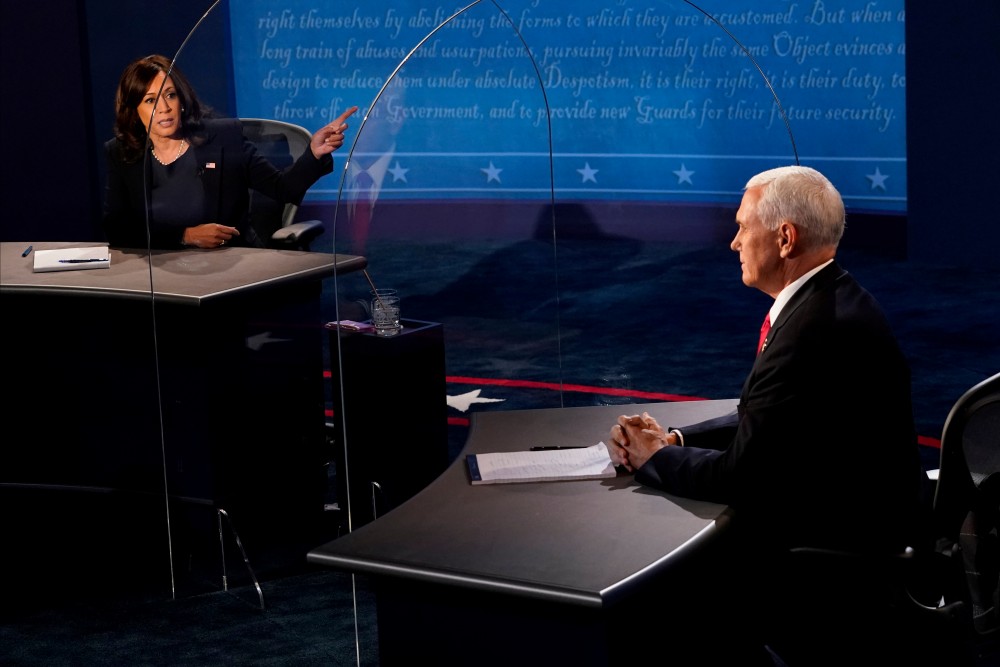 Democratic vice presidential nominee and U.S. Senator Kamala Harris answers a question as U.S. Vice President Mike Pence watches, during the 2020 vice presidential debate on the campus of the University of Utah in Salt Lake City, Utah, U.S., October 7, 2020.  Morry Gash/Pool via REUTERS
