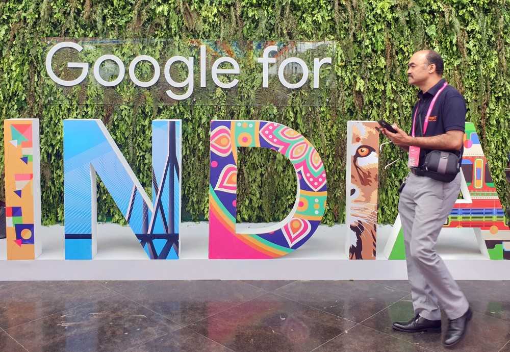 FILE PHOTO: A man walks past the sign of "Google for India", the company's annual technology event in New Delhi, India, September 19, 2019. REUTERS/Sankalp Phartiyal/File Photo