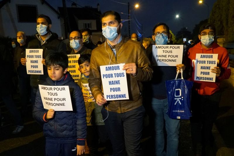 People attend a silent march to pay tribute to Samuel Paty, the French teacher who was beheaded on the streets of the Paris suburb of Conflans-Sainte-Honorine, France, October 20, 2020. The slogan reads "Love for all, hatred for no-one".  (REUTERS Photo)