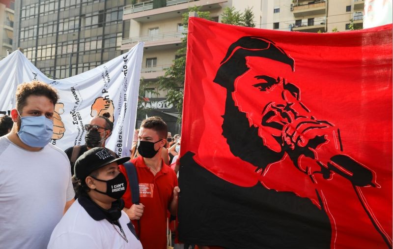 A banner depicting anti-racist Greek rapper Pavlos Fyssas is seen, as demonstrators protest ahead of a trial of leaders and members of the far-right Golden Dawn, in Athens, Greece on October 7, 2020. (REUTERS Photo)