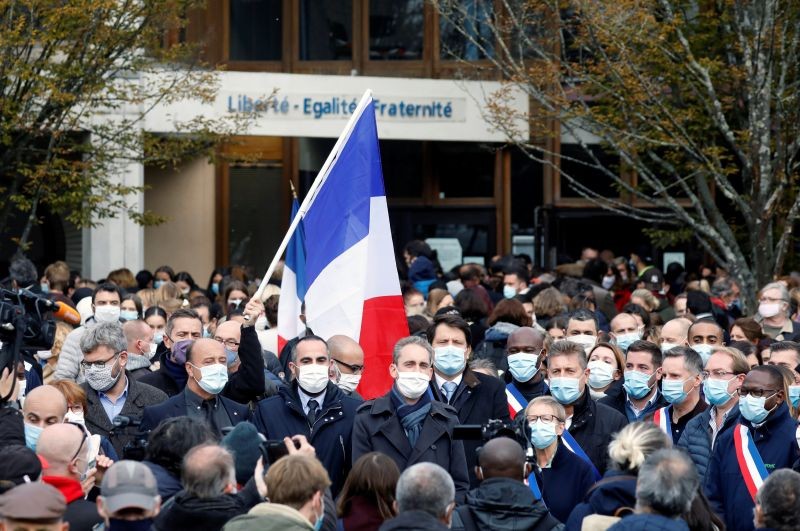 People gather in front of the Bois d'Aulne college after the attack in the Paris suburb of Conflans St Honorine, France, October 17, 2020. REUTERS/Charles Platiau