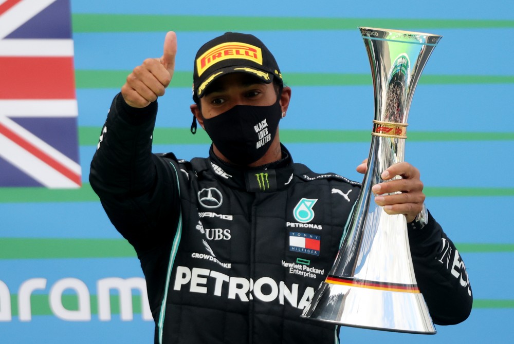 Formula One F1 - Eifel Grand Prix - Nurburgring, Nurburg, Germany - October 11, 2020 Mercedes' Lewis Hamilton celebrates with a trophy on the podium after winning the race Pool via REUTERS/Wolfgang Rattay