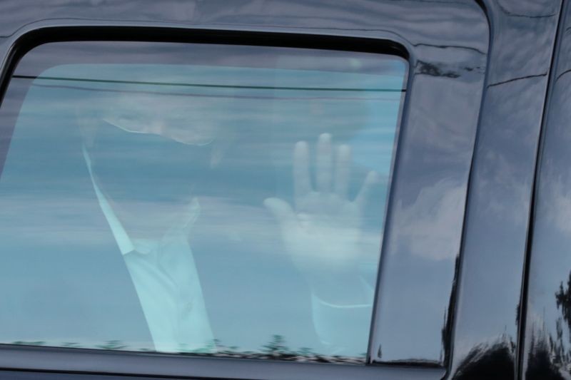 U.S. President Donald Trump rides in front of  the Walter Reed National Military Medical Center, where he is being treated for the coronavirus disease (COVID-19) in Bethesda, Maryland, U.S. October 4, 2020.  (REUTERS Photo)