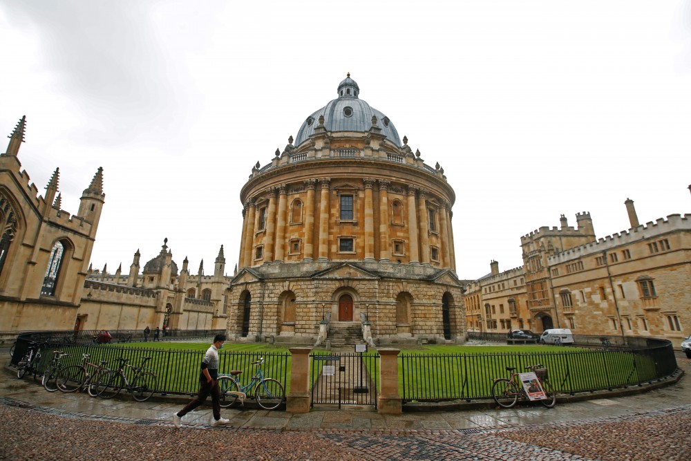 A man walks in front of the buildings of Oxford University, amid the spread of the coronavirus disease (COVID-19) in Oxford, Britain, October 6, 2020. REUTERS/Matthew Childs