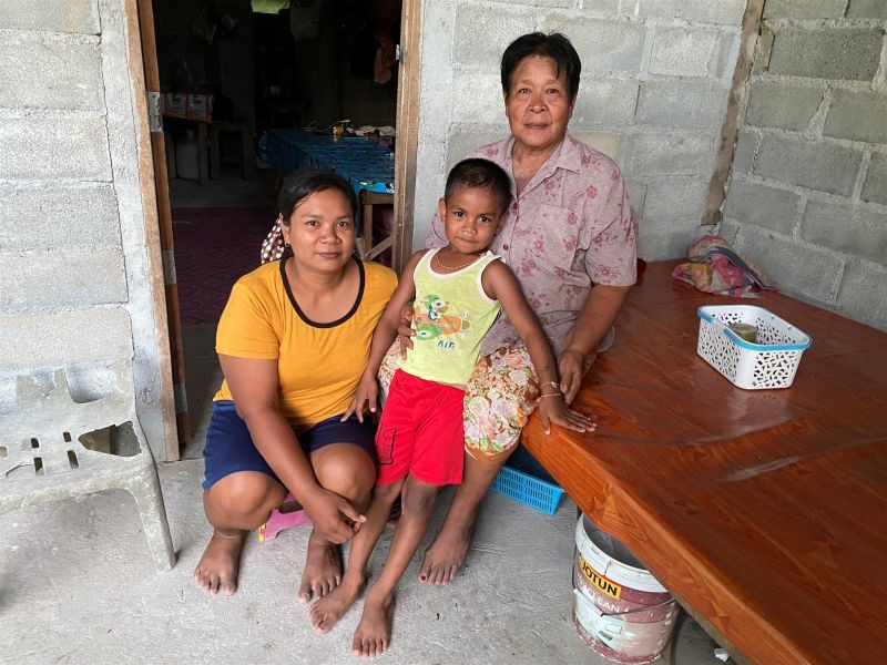 The family of Chai Bunthonglek, a farmer who was killed in 2015 in a community farm in Klong Sai Pattana in Surat Thani province in southern Thailand on August 24, 2020. (Thomson Reuters Foundation File Photo)