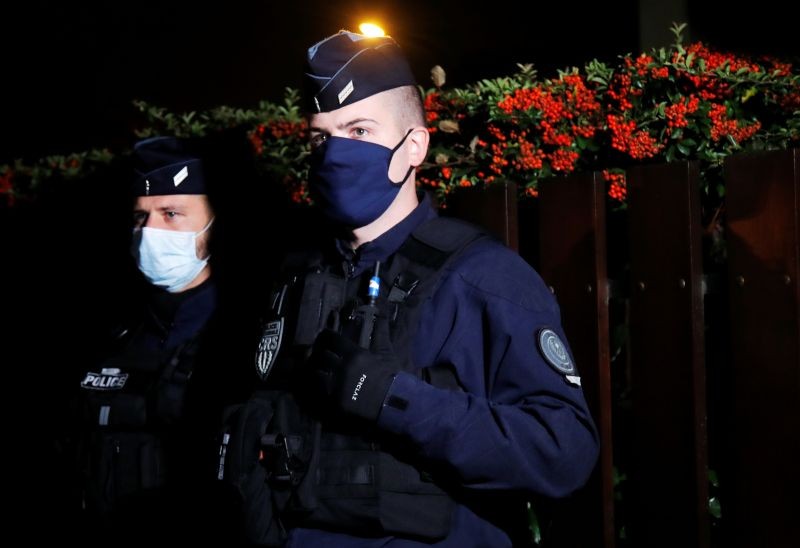 Police officers secure the area near the scene of a stabbing attack in the Paris suburb of Conflans St Honorine, France, October 16, 2020. REUTERS/Charles Platiau