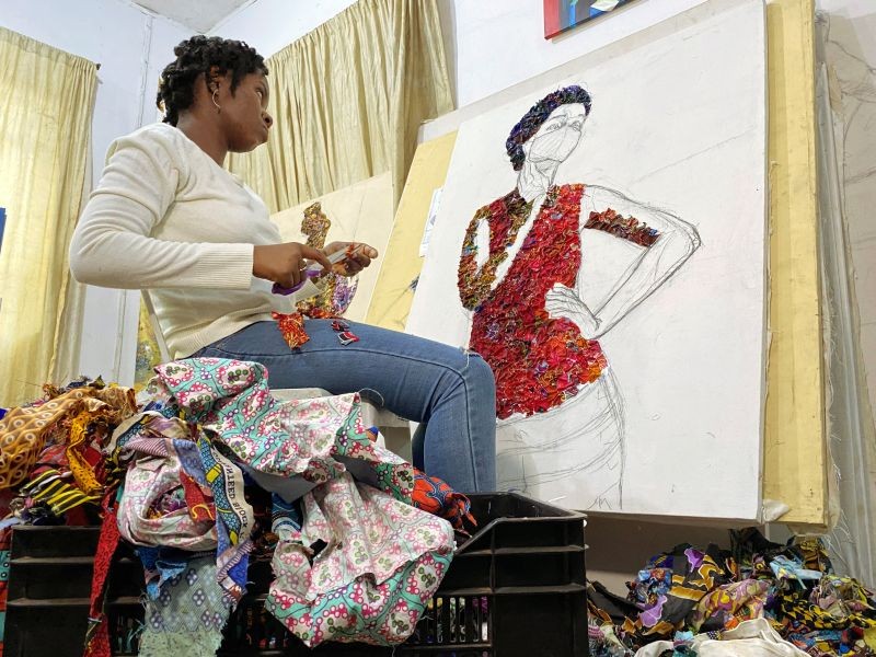 Marcellina Akpojotor creates an art piece of a woman with a face mask using waste Ankara fabric in Lagos, Nigeria on August 18, 2020. (REUTERS File Photo)