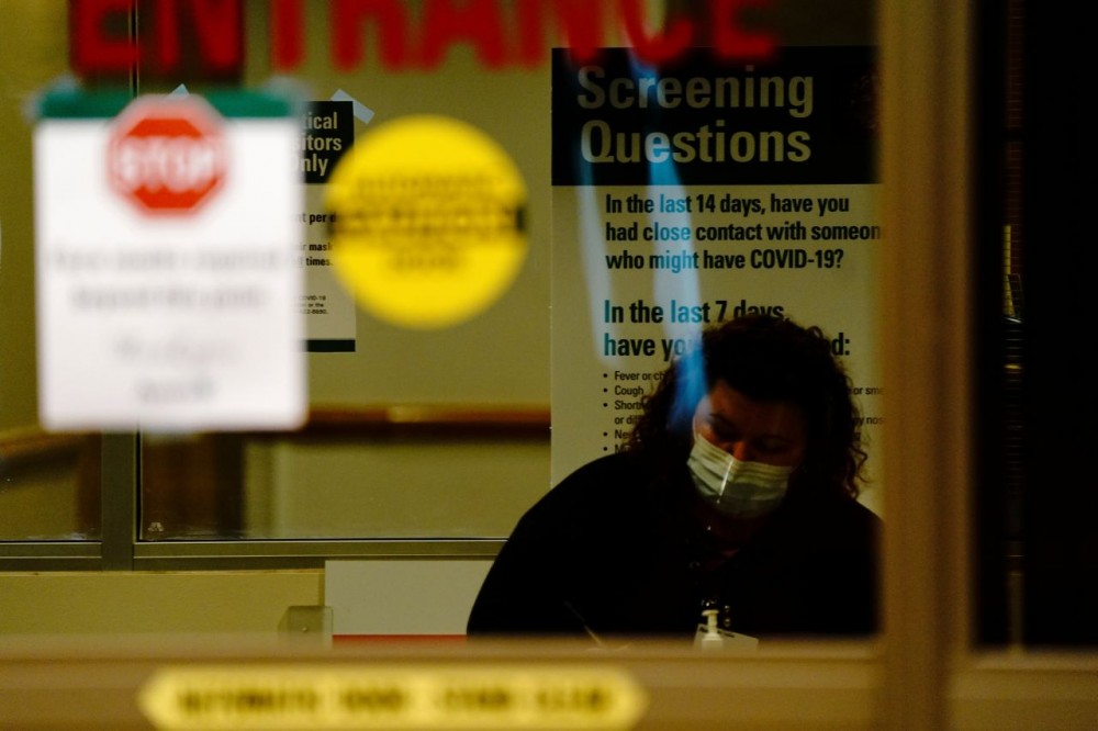 FILE PHOTO: A healthcare worker questions a patient (not pictured) arriving at the emergency room of Avera St. Luke's Hospital as the coronavirus disease (COVID-19) outbreak continues in Aberdeen, South Dakota, U.S., October 26, 2020. REUTERS/Bing Guan