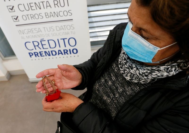 Lorena Rodriguez, 47, who worked in the informal sector as a nanny, shows a gold bracelet before pawning it at a state-run pawnbroker, during the coronavirus disease (COVID-19) pandemic, in Quilpue, Chile August 12, 2020. (REUTERS File Photo)