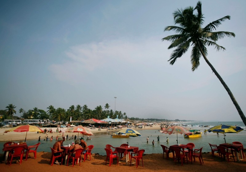 Tourists relax at a cafe on Baga beach in Goa, March 16, 2008. REUTERS/Punit Paranjpe/File Photo