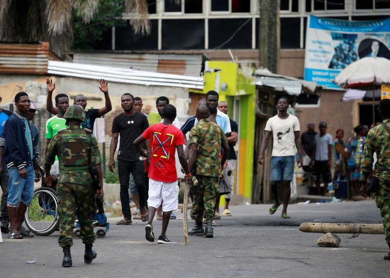 Military personnel move towards people standing along a blocked road in Ikeja, as Nigeria's Lagos state remains under curfew, Nigeria October 23, 2020. (REUTERS Photo)