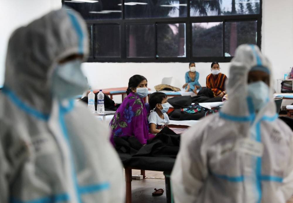 FILE PHOTO: A woman sits with her child inside a quarantine centre for the coronavirus disease (COVID-19) patients amidst the spread of the disease at an indoor sports complex in New Delhi, India, September 22, 2020. REUTERS/Anushree Fadnavis