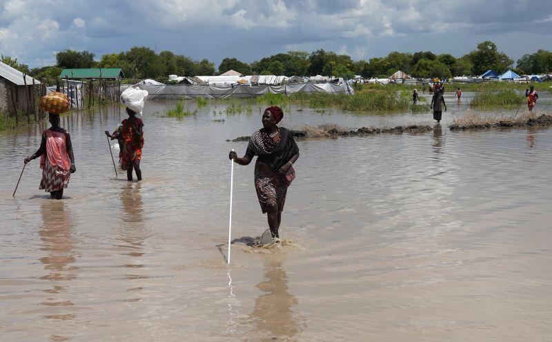 Women wade through flood waters after the River Nile broke the dykes in Pibor, Greater Pibor Administrative Area, South Sudan October 6, 2020. (REUTERS Photo)