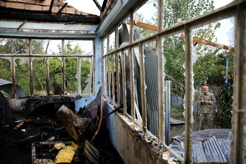 A local inspects the house hit by a rocket during the fighting over the breakaway region of Nagorno-Karabakh in the village of Baharli, Azerbaijan October 15, 2020. REUTERS/Umit Bektas