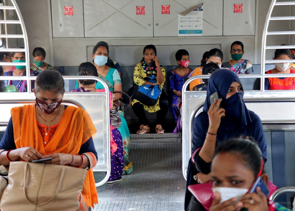 REUTWomen wearing protective face mask commute in a suburban train after authorities resumed the train services for women passengers during non-peak hours, amidst the coronavirus disease (COVID-19) outbreak, in Mumbai, India, October 21, 2020. REUTERS/Niharika KulkarniERS photo