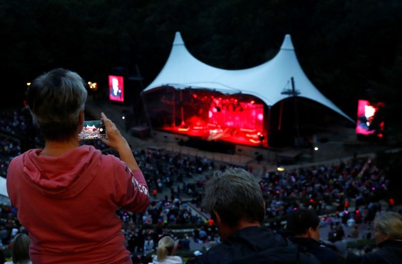 A person uses a mobile phone as Roland Kaiser performs on stage of Berlin Waldbuehne amphitheatre as it reopens following the coronavirus disease (COVID-19) outbreak, in Berlin, Germany September 3, 2020. (REUTERS File Photo)