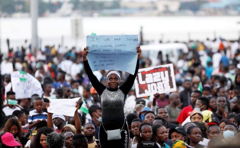 A demonstrator holds a sign during protest over alleged police brutality in Lagos, Nigeria October 17, 2020. Picture taken October 17, 2020. (REUTERS File Photo)