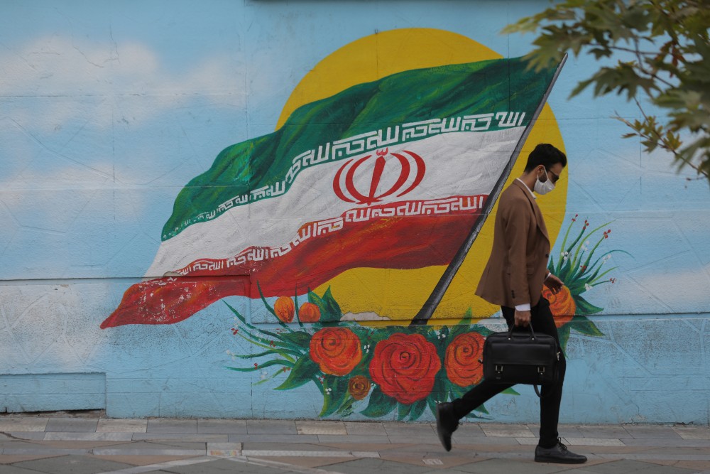 An Iranian man wearing a face mask walks on a street after Iranian authorities made it mandatory for all to wear face masks in public following the outbreak of the coronavirus disease (COVID19), in Tehran Iran October 10, 2020. Majid Asgaripour/WANA (West Asia News Agency) via REUTERS