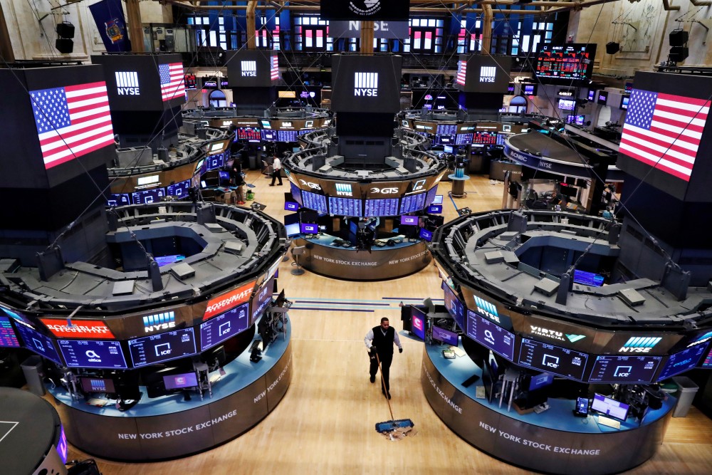 FILE PHOTO: A worker cleans the floor of the New York Stock Exchange (NYSE) , U.S., March 20, 2020. REUTERS/Lucas Jackson/File Photo