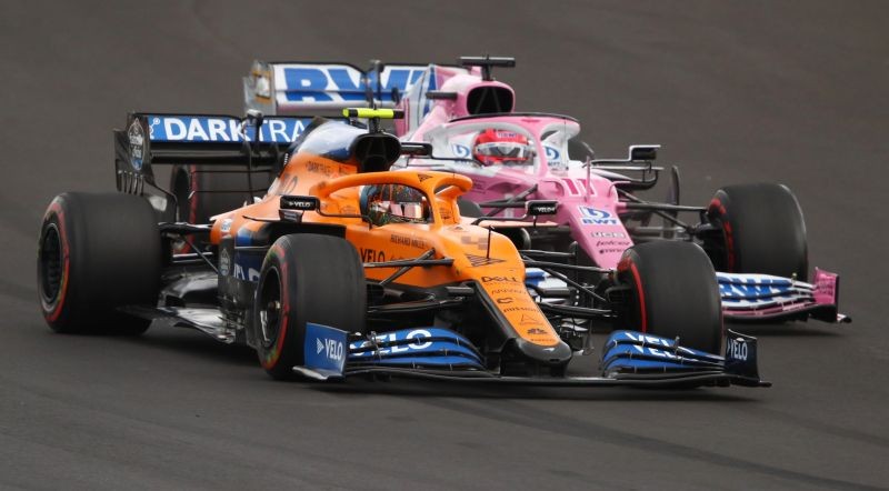 McLaren's Lando Norris and Racing Point's Sergio Perez in action during the race Pool via REUTERS/Bryn Lennon