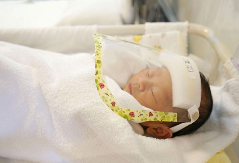 A newborn baby wearing a face shield as a protection from the coronavirus disease (COVID-19), is seen at maternity hospital Wise Ladies' Clinic in Satte, north of Tokyo, Japan, in this photo taken by Kyodo May 10, 2020. (REUTERS File Photo)