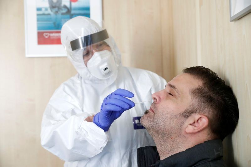 A healthcare worker collects a swab sample from a man at a COVID-19 testing site as the spread of the coronavirus disease (COVID-19) continues in Budapest, Hungary, October 27, 2020. (REUTERS Photo)