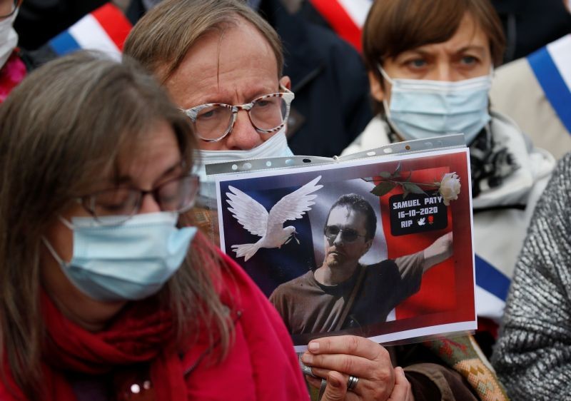 A person holds a picture of Samuel Paty, the French teacher who was beheaded on the streets of the Paris suburb of Conflans St Honorine, during a tribute at the Place de la Republique, in Lille, France, October 18, 2020. (REUTERS Photo)