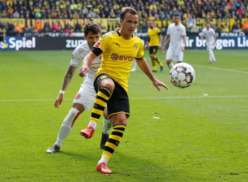 Borussia Dortmund's Mario Goetze in action with Fortuna Dusseldorf's Matthias Zimmermann REUTERS/Leon Kuegeler/Files
