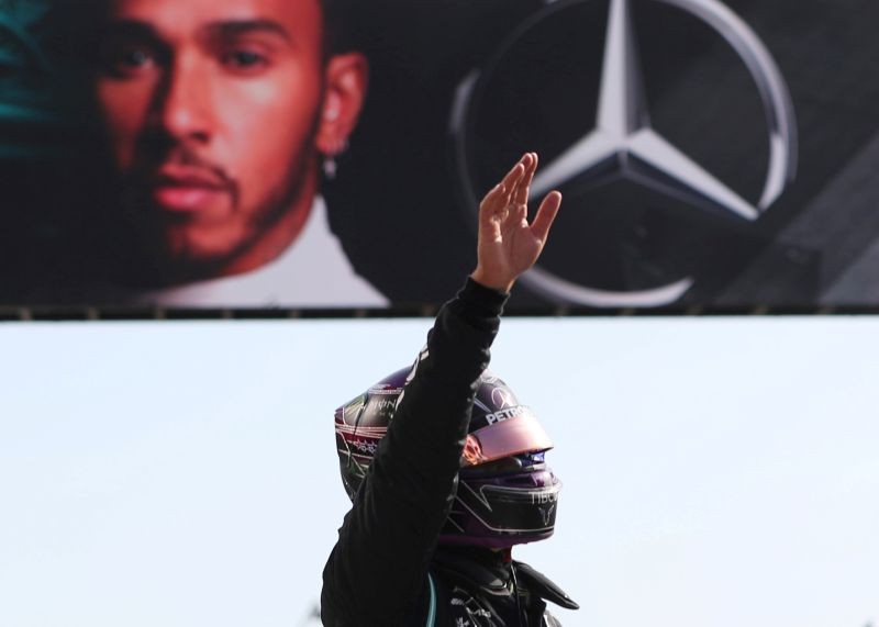 Mercedes' Lewis Hamilton celebrates after qualifying in pole position Pool via REUTERS/Jose Sena Goulao