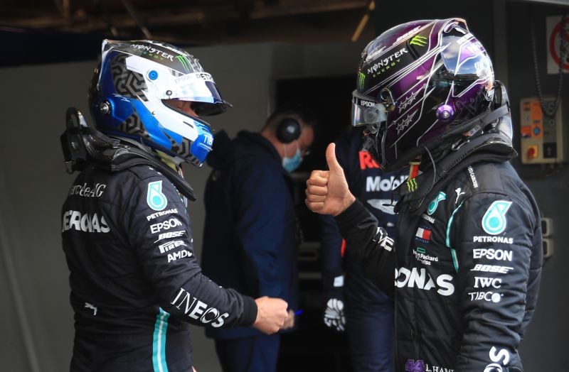 Mercedes' Valtteri Bottas celebrates after qualifying pole position with Mercedes' Lewis Hamilton who qualified second Pool via REUTERS/Wolfgang Rattay